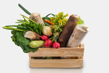 Wooden box with fresh vegetables and organic greens on white background. Bio organic food. Detox...