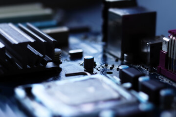 Blurred computer motherboard closeup in tilt shift style with selective focus. Defocused computer parts background