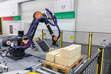 Robotic arm's picking the box.