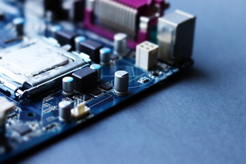 Blurred computer motherboard closeup in tilt shift style with selective focus. Defocused computer parts background