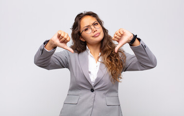  looking sad, disappointed or angry, showing thumbs down in disagreement, feeling frustrated