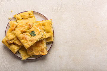 Homemade pie recipe. Pie with meat filling on a light table, top view, copy space
