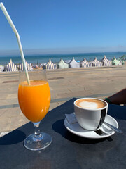 Coffee and orange juice breakfast facing the sea