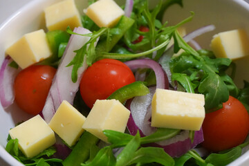 Green salad with cheese in a bowl of green salad, vegetarian or vegan food.