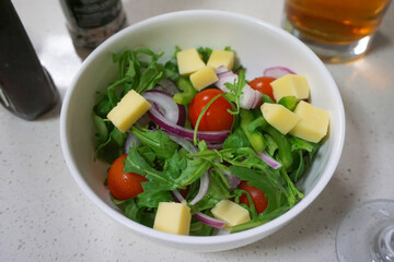 Green salad with cheese in a bowl of green salad, vegetarian or vegan food.