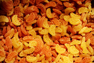 Pile of Lemon and Orange hard candies in a candies store - background