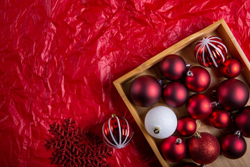 Christmas ornaments, red balls on red background. Merry Christmas and Happy New Year, holiday concept. Top view. Copy space.