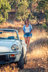 Woman with white convertible vintage car