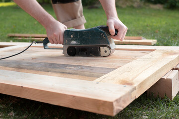 real work. worker grinds a wooden product. 