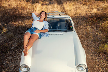 Woman with white convertible vintage car