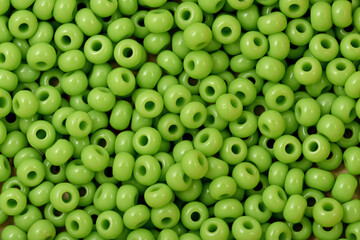 Light green Beads on the white background. Background or texture of beads. Close up, macro,It is used in finishing fashion clothes. make bead necklace or string of beads for woman of fashion.