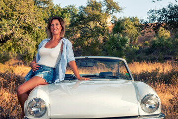 Woman with white convertible vintage car