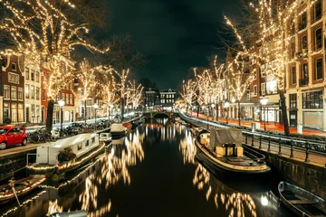 Foto auf Glas Amsterdam canal at night with Christmas lights on the trees © Woodenmen
