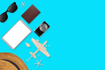 Flat lay of traveler accessories on blue background with blank space for text. Top view travel or vacation concept. Summer background.