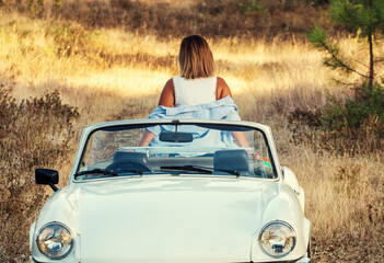 Woman with white convertible vintage car