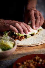 man preparing a durum or a burrito