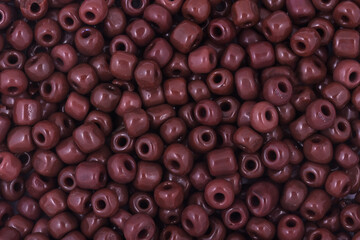 Brown Beads on the white background. Background or texture of beads. Close up, macro,It is used in finishing fashion clothes. make bead necklace or string of beads for woman of fashion.