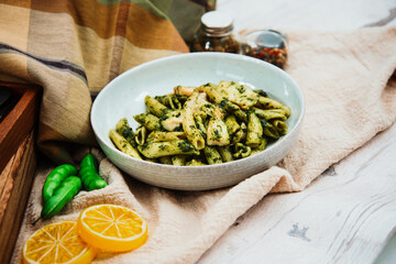 close-up of plate of pasta and chicken with lettuce