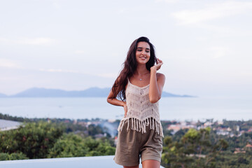 Portrait of happy caucasian calm  romantic woman in casual look with long hair wearing earings and necklace on background amazing beautiful view on green mountains  