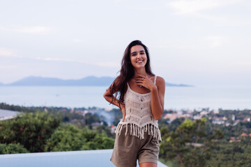 Portrait of happy caucasian calm  romantic woman in casual look with long hair wearing earings and necklace on background amazing beautiful view on green mountains  