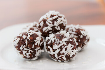 Obraz na płótnie Canvas Closeup on chocolate treats covered in coconut flakes