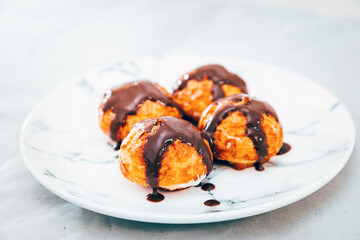 Profiterole with vanilla and chocolate sauce