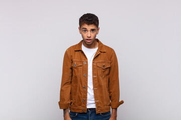  feeling puzzled and confused, with a dumb, stunned expression looking at something unexpected