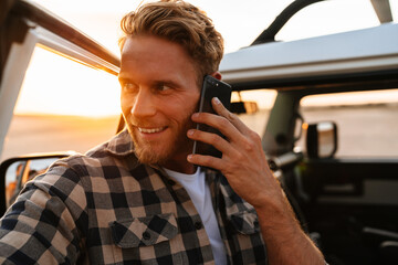 Handsome young man using mobile phone