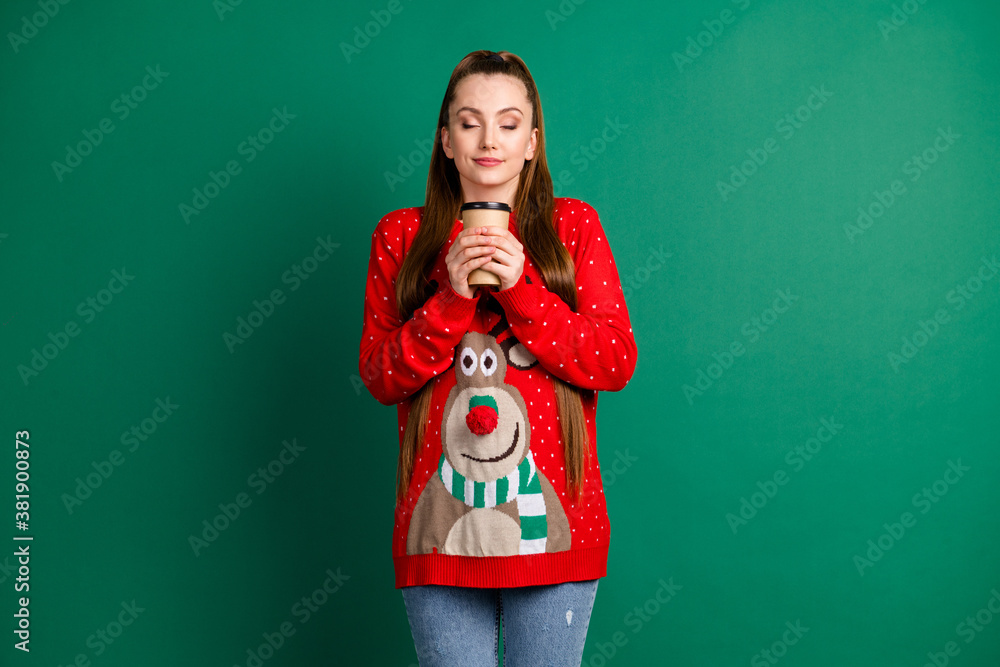 Sticker Photo of charming attractive lady hold hands hot coffee to go beverage pleasant aroma eyes closed newyear mood magic morning atmosphere wear red ugly sweater isolated green color background