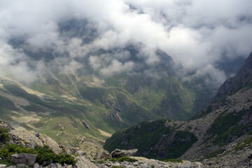 Alpine valley in the clouds. Kabardino-Balkarian natural reserve. Caucasus, Russia.
