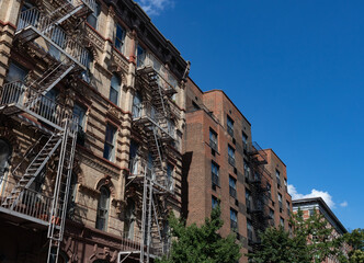 Row of Colorful Old Brick Residential Buildings with Fire Escapes in Greenwich Village of New York City