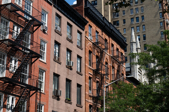 Row of Colorful Old Brick Residential Buildings with Fire Escapes in Greenwich Village of New York City © James