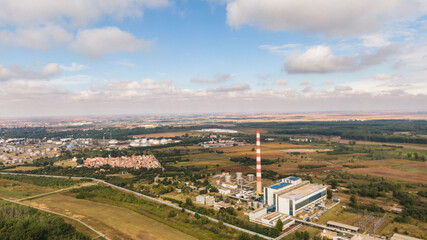 Drone footage from an industrial chimney on a sunny day. Plant in the frame