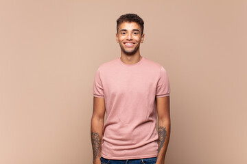  smiling happily with a hand on hip and confident, positive, proud and friendly attitude