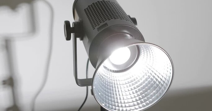A man install studio video lighting equipment