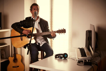 guitar player recording at home studio