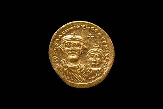Gold Roman solidus coin of Roman Emperor Justinian I AD527-265 cut out and isolated on a black background stock photo Image
