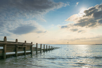 East Head, West Wittering, Chichester Harbour, England. A tranquil evening scene of partly cloudy sky and calm a sea.