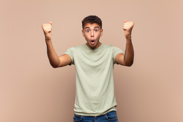  celebrating an unbelievable success like a winner, looking excited and happy saying take that!