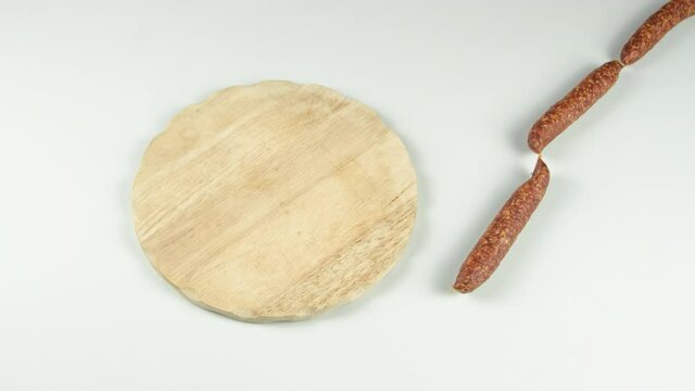 stop motion of South Tyrolean snack dish such as Tyrolean smoked sausage on a wooden cutting board accompanied by kaminwurz and paarl type bread