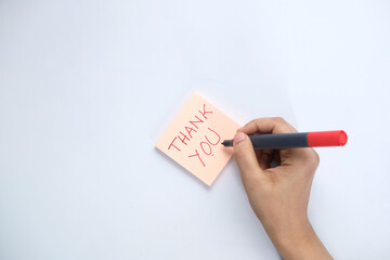 women's hand writing thank you note 