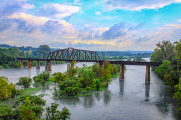 Looking off the top of the Cotter Bridge out over the White River and Railroad bridge in Cotter,...