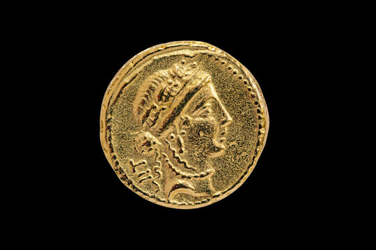 Roman Aureus Gold Coin replica of Julius Caesar with a probable head of the goddess Venus on the front struck between 48-47 BC cut out and isolated on a black background stock photo Image