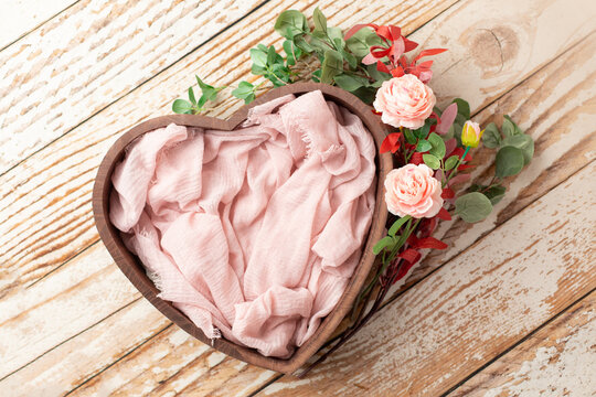 heart of wood decorated with roses. basket for newborn photo shoot. pink rose. heart