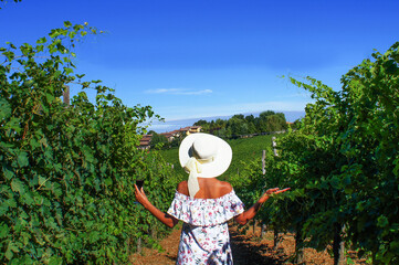 young girl in a hat  on the vineyard