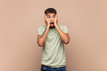  feeling happy, excited and surprised, looking to the side with both hands on face