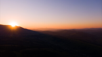 Fototapeta premium Sun setting over hills. Carpathian mountains in Ukraine.