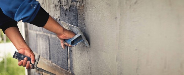 Concrete plasterers to create industrial workers background walls with plastering tools. - obrazy, fototapety, plakaty