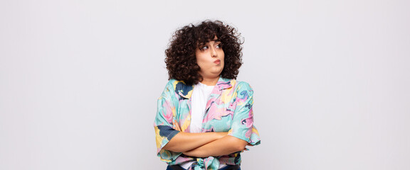  shrugging, feeling confused and uncertain, doubting with arms crossed and puzzled look