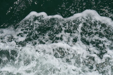 Seafoam or spume on seawater stock photo